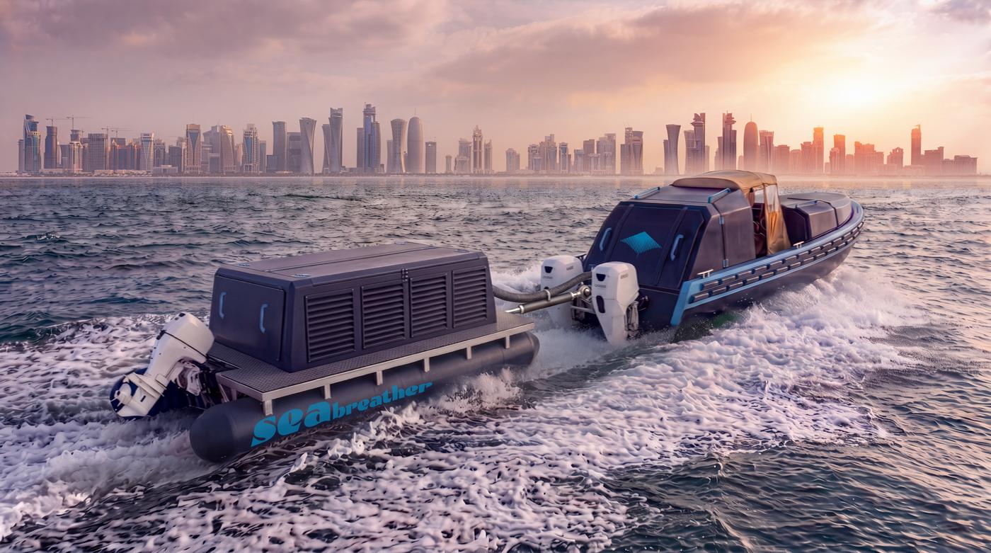 A Super SeaBreather with its gas barge alongside, running past the Doha skyline at sunset