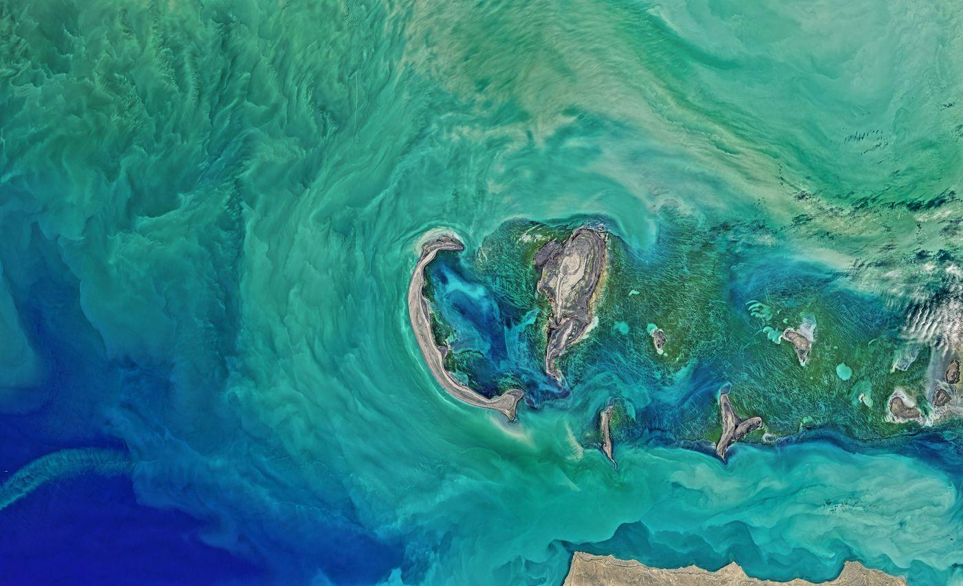 Aerial photograph of island formations surrounded by open ocean
